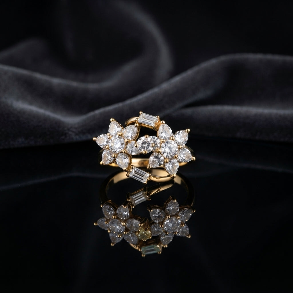Gold Double Flower Cluster CZ Cocktail Ring in all-white baguette CZ accent variant — luxury flat-lay on mirror surface with dark silk backdrop