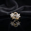 Gold Double Flower Cluster CZ Cocktail Ring in all-white baguette CZ accent variant — luxury flat-lay on mirror surface with dark silk backdrop