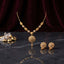 Gold Filigree Globe Pendant and Round Filigree Drop Earrings Necklace Set — 22K antique gold-tone 2-piece set with flat snake chain with oval filigree station beads large open spherical filigree cartwheel globe pendant with gold cone drop and matching round open filigree drop earrings displayed on dark grey marble surface with crystal quartz and gold nugget props and dark crimson velvet backdrop