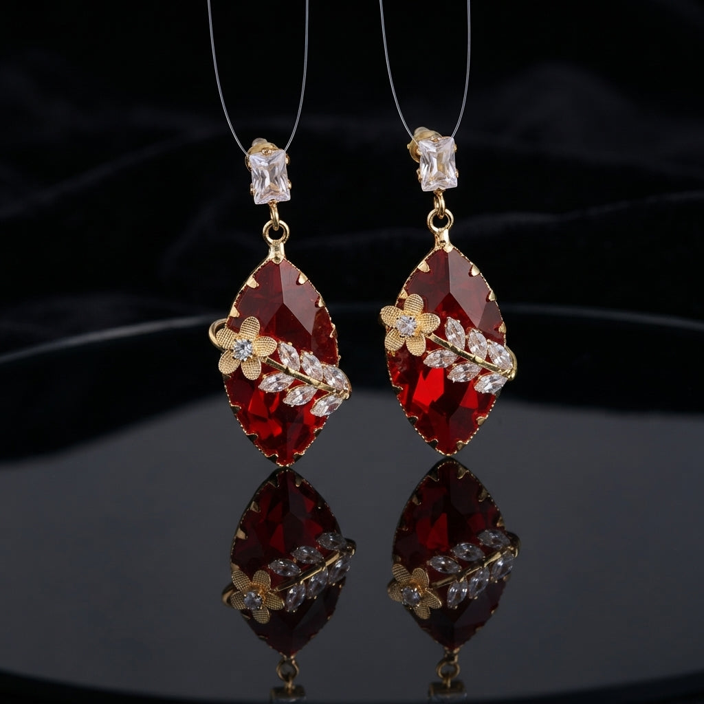 Gold Floral CZ Leaf Crystal Gem Drop Earrings in Smoky Mauve showing pair suspended on monofilament wire against dark silk backdrop with baguette CZ stud top large faceted diamond-shape smoky mauve crystal drop with gold daisy flower and marquise CZ leaf sprig overlay and mirror reflection below