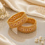 Gold-Tone Wide Granule Triple Row Polki & Ruby CZ Kada Bangle Set of 2 on cream marble surface with ivory silk fabric and baby's breath flowers backdrop