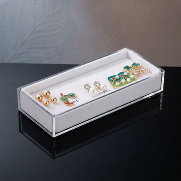 Gold Green Floral Enamel Pearl CZ 4-Pair Stud Earring Set displayed in open clear acrylic gift box on black surface with grey and beige fabric backdrop showing all four pairs arranged on white velvet insert with mirror reflection below