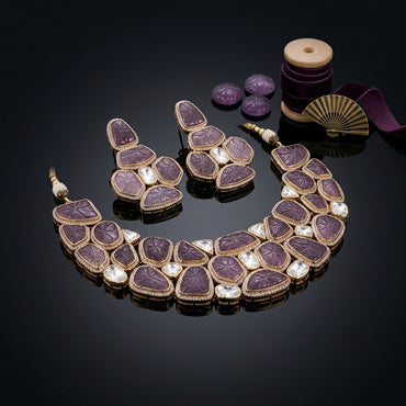 Gold-Tone Hand-Carved Amethyst Purple Polki & Rose-Cut CZ Kundan Wide Choker Necklace & Drop Earrings Bridal Set on black mirror surface with carved amethyst stones, gold fan and purple velvet ribbon backdrop