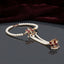 Gold Kundan Lotus Pearl Hath Phool Hand Harness Bracelet Ring in White Ivory variant worn by Pakistani female model in blush pink bridal outfit showing white MOP kundan lotus hath phool with fine pearl bracelet and 3 strand seed pearl hand chain connecting to finger ring in luxury bridal boutique backdrop