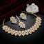 Gold-Tone Kundan Marquise & Pearl Choker, Earrings & Maang Tikka Bridal Set flat lay on black mirror surface with white quartz crystal cluster and deep burgundy velvet fabric backdrop