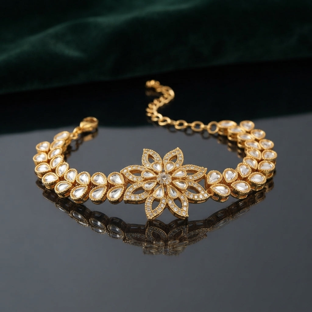 Gold Kundan Polki Star Flower Bracelet in Ruby Red CZ variant flat lay on dark grey mirror surface with charcoal satin backdrop showing double-row kundan polki navette link band with large 8-petal star flower focal with ruby red CZ pave petal fill and white polki navette band with mirror reflection