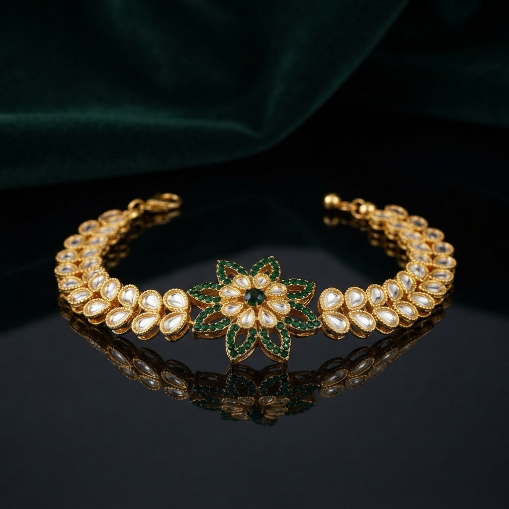 Gold Kundan Polki Star Flower Bracelet in White CZ variant flat lay on grey mirror surface with green velvet backdrop showing double-row kundan polki navette link band with large 8-petal star flower focal with white CZ open filigree petal arms and white polki navette band with mirror reflection