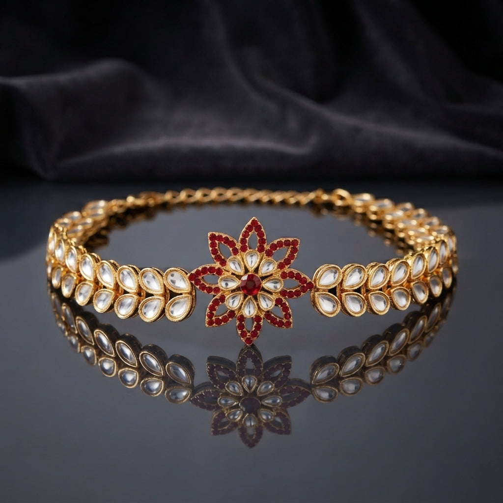 Gold Kundan Polki Star Flower Bracelet in Ruby Red CZ variant worn on wrist of female model in burgundy blazer on dark wood table showing large 8-petal star flower focal with ruby red CZ pave petal fill and white polki navette double-row band with adjustable extension chain