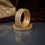 Gold Kundan Round Polki Stone Wide Bangle Set of 4 standing upright on dark grey mirror surface with burgundy velvet and gold embroidered fabric backdrop showing four matching wide bangles with three rows of round kundan polki flat-cut CZ stones in gold-tone bezel settings and filigree granulation back with mirror reflection below