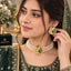 Gold-Tone Kundan Ruby Red & Emerald Green CZ Diamond Lattice Centrepiece 3-Strand Pearl Choker Necklace & Earrings Set worn on bridal model in dark green embroidered lehenga with dupatta and floral backdrop
