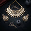 22K Gold-Tone Large Freeform Polki Kundan & Pearl Drop Onyx Bead Elephant Motif Choker Necklace & Jhumka Chandelier Earrings Bridal Set on black mirror surface with antique gold scissors, grey thread spools and burgundy silk fabric backdrop