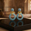 Gold Leaf CZ Pavé Circle Drop Earrings in Multi Color in 18K gold-tone plating on grey mirror surface with warm Mughal palace backdrop showing round dome ball stud top and large open circle drop fully covered in dense multi-color micro-pavé CZ stones in ruby red emerald green sapphire blue and white CZ with gold leaf connector and mirror reflection below
