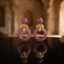 Gold Leaf CZ Pavé Circle Drop Earrings in Turquoise Blue color in 18K gold-tone plating on dark black tray surface with warm interior Mughal backdrop showing round dome ball stud top and large open circle drop fully covered in dense turquoise blue micro-pavé CZ stones with gold leaf connector and mirror reflection below