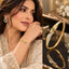 Gold Leaf Pave CZ Wave Rigid Bangle collage showing lifestyle shot of model in ivory formal embroidered suit wearing gold bangle on wrist and product flat lay on dark mirror surface with gold decor backdrop showing asymmetric curved micro-pave white CZ wave panel with polished gold leaf overlay and hinge clasp