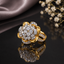 Gold Lotus Flower Cluster CZ Dome Cocktail Ring in White — 22K gold-tone lotus flower basket ring with dense all-white large round CZ dome cluster crown, white CZ pavé petal halo, and split pavé shank, on dark mirror surface with taupe silk and floral backdrop