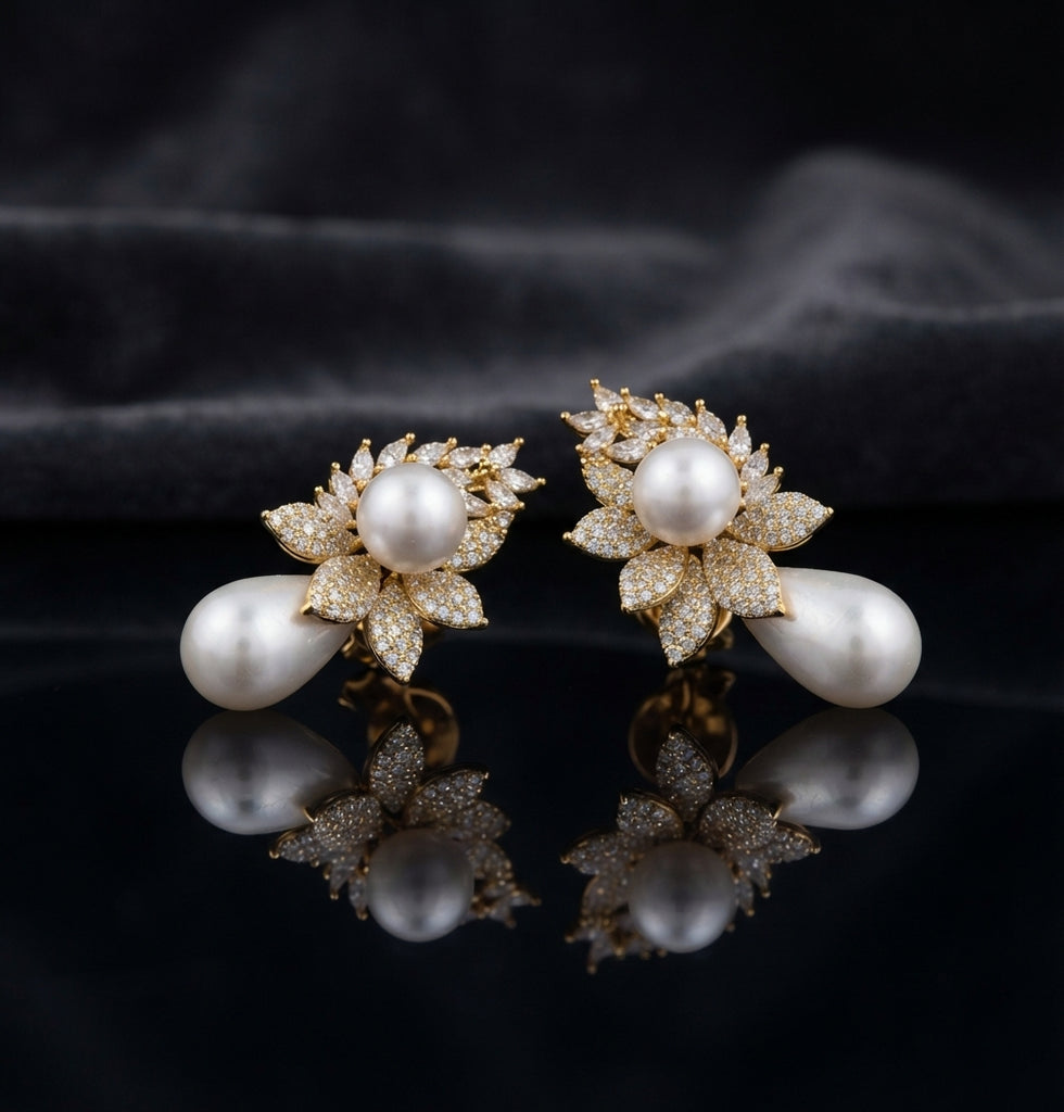 Gold-Tone Marquise CZ Wheat Leaf Cluster Double Pearl Drop Earrings on black mirror surface with dark grey silk fabric backdrop