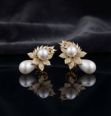 Gold-Tone Marquise CZ Wheat Leaf Cluster Double Pearl Drop Earrings on black mirror surface with dark grey silk fabric backdrop
