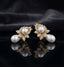 Gold-Tone Marquise CZ Wheat Leaf Cluster Double Pearl Drop Earrings on black mirror surface with dark grey silk fabric backdrop