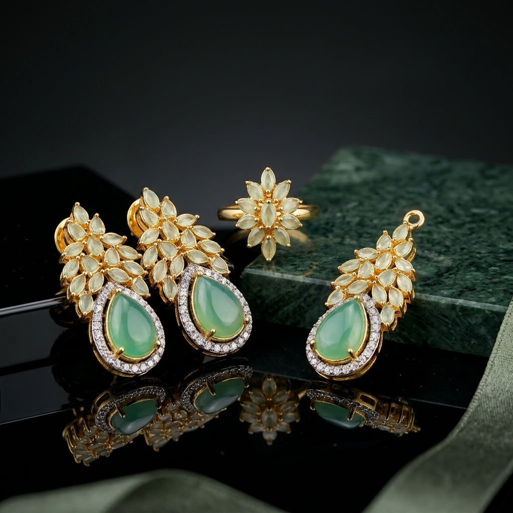 Gold-Tone Marquise & Pear CZ Sunburst Floral Crown Pavé Halo Pendant Necklace Earrings & Ring Jewelry Set in Mint Jade Green on black mirror surface with green marble and sage green silk fabric backdrop