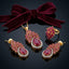 Gold-Tone Marquise & Pear CZ Sunburst Floral Crown Pavé Halo Pendant Necklace Earrings & Ring Jewelry Set in Ruby Red on dark mirror surface with burgundy velvet bow ribbon backdrop