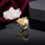 Gold-Tone Micro-Pavé CZ Feather Wheat Leaf & Pearl Center Open Adjustable Statement Ring on black mirror surface with white crystal quartz cluster and deep burgundy velvet backdrop