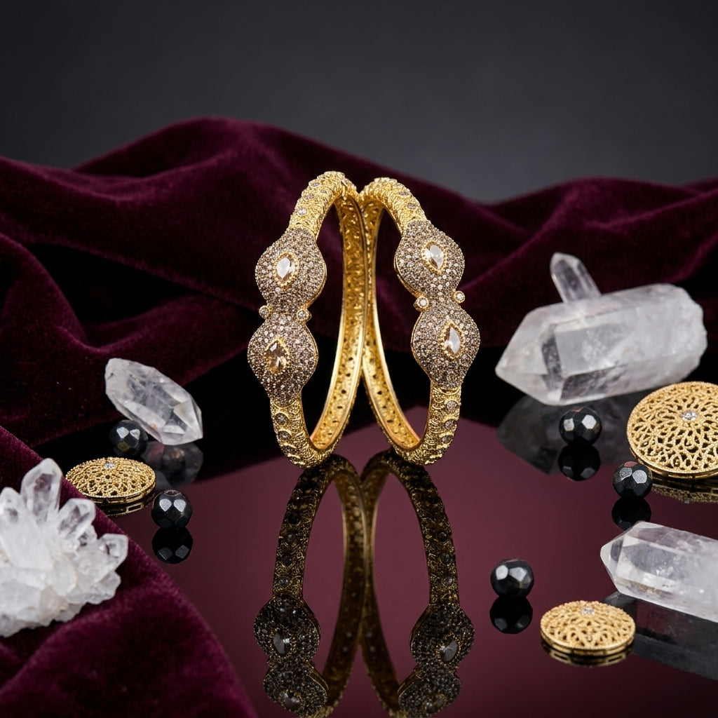 Gold-Tone Micro-Pavé CZ & Kundan Polki Marquise Triple Dome Filigree Openwork Kara Bangle Set of 2 standing upright on dark mirror surface with white crystal quartz clusters, black onyx beads, gold filigree discs and deep burgundy velvet backdrop