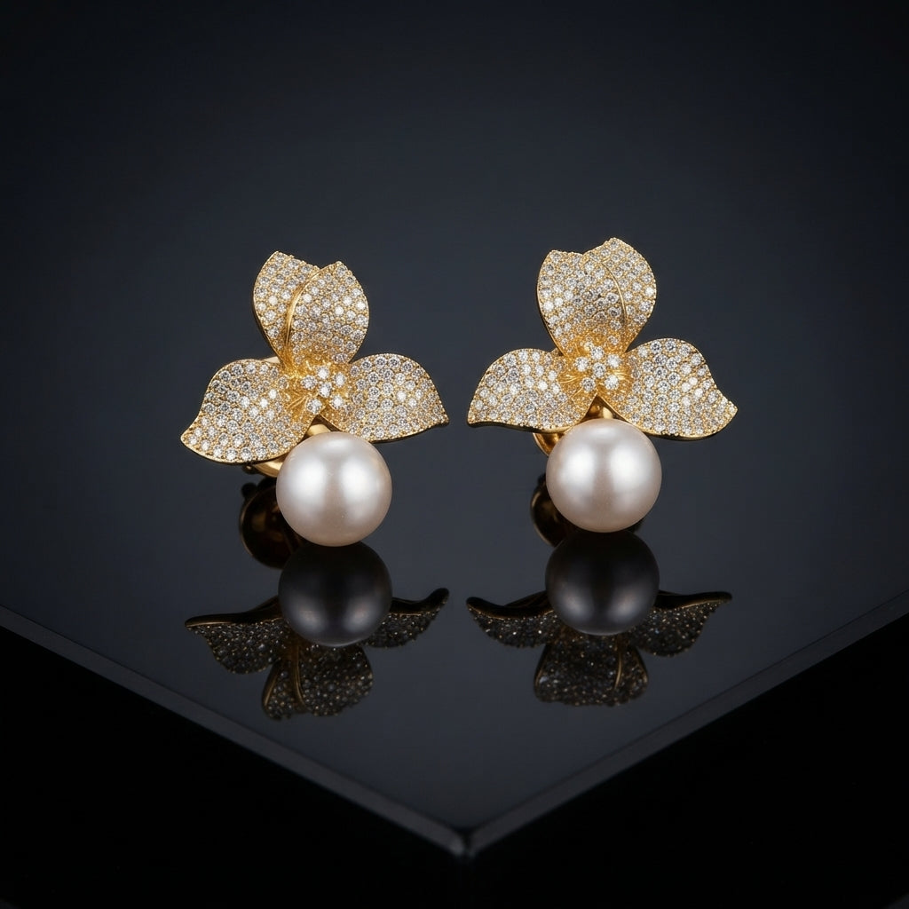 Gold-Tone Micro-Pavé CZ Triple Leaf Flower Cap & South Sea Pearl Stud Earrings on black mirror surface with dark background