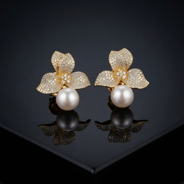 Gold-Tone Micro-Pavé CZ Triple Leaf Flower Cap & South Sea Pearl Stud Earrings on black mirror surface with dark background