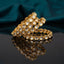 Gold Mixed-Shape Kundan Polki Teardrop Oval Full-Bezel Slim Bangle Set of 4 standing upright on dark grey mirror surface with teal silk backdrop showing four matching slim gold bangles fully encircled with alternating teardrop and oval flat-cut CZ kundan polki stones in antique gold individual bezel settings with mirror reflection below