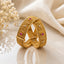 Gold-Tone Mughal Scroll Filigree Ruby & White CZ Square Panel Kada Bangle Set of 2 on cream marble surface with white silk fabric and baby's breath flowers backdrop