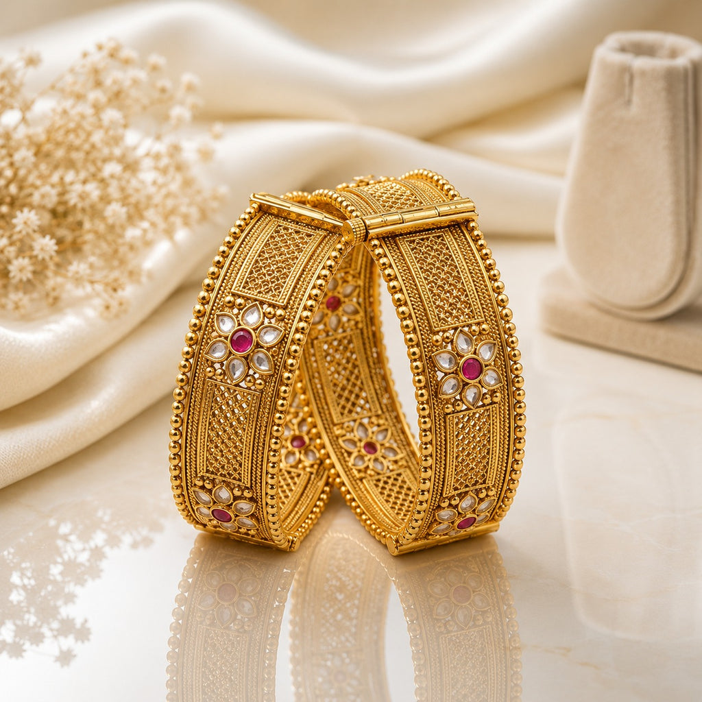 Gold-Tone Mughal Square Panel Kundan Polki Flower & Ruby CZ Kada Bangle Set of 2 on cream marble surface with white silk fabric and dried flower stems backdrop