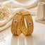 Gold-Tone Mughal Square Panel Kundan Polki Flower & Ruby CZ Kada Bangle Set of 2 on cream marble surface with white silk fabric and dried flower stems backdrop
