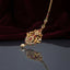 Gold Multi-Color CZ Mughal Twin Peacock Maang Tikka with Pearl Drop — antique 22K gold-tone South Asian bridal maang tikka with large diamond-shaped Mughal twin peacock pendant featuring marquise ruby CZ wing fills emerald green CZ accents white CZ micro-pavé scrollwork and single cream pearl drop on fine gold CZ chain displayed on dark grey mirror surface with burgundy velvet backdrop