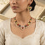 Gold Multicolor Enamel Daisy Flower Pearl Cluster Choker Necklace Earrings Set product flat lay on dark grey mirror surface with blue silk backdrop showing V-bib choker and matching earrings with multicolor enamel daisies and pearl clusters