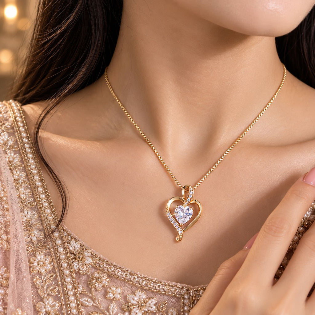 Gold Open Heart CZ Solitaire & Pavé Arm Pendant Necklace worn by bridal model in blush gold embroidered lehenga with gold bokeh backdrop
