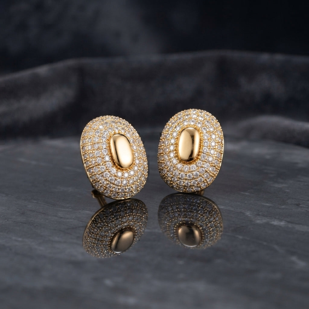 Silver-tone oval pavé stud earrings with smooth oval centers.