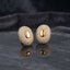 Silver-tone oval pavé stud earrings with smooth oval centers.