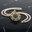 gold-plated double strand pearl necklace with a circular pendant featuring Arabic Allah calligraphy surrounded by a sunburst crystal halo, shown on a dark reflective surface.
