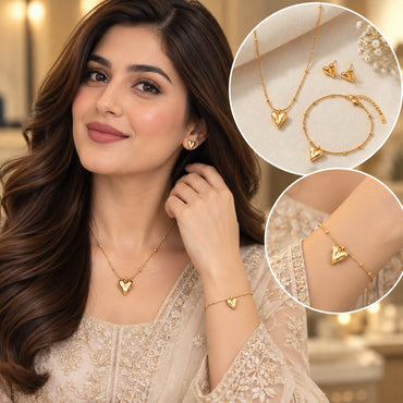 Gold Puffy Heart Pendant Necklace Bracelet and Earrings Set composite image showing Pakistani female model in ivory cream embroidered kurta wearing full 3-piece gold puffy heart set with fine satellite chain necklace and matching bracelet and stud earrings with top right inset product flat lay on white with gypsophila flowers and bottom right inset wrist bracelet closeup