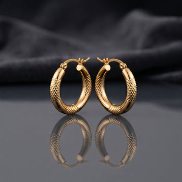 Gold PVD Stainless Steel Diamond-Cut Texture and Smooth Tube Hoop Earrings pair standing side by side on dark mirror surface with charcoal slate satin backdrop showing 18K gold PVD coated stainless steel hoops with diamond-cut pyramid texture outer half smooth mirror-polish inner half and polished barrel accent cap at base with French lever closure and sharp mirror reflection below