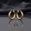 Gold PVD Stainless Steel Diamond-Cut Texture and Smooth Tube Hoop Earrings pair standing side by side on dark mirror surface with charcoal slate satin backdrop showing 18K gold PVD coated stainless steel hoops with diamond-cut pyramid texture outer half smooth mirror-polish inner half and polished barrel accent cap at base with French lever closure and sharp mirror reflection below