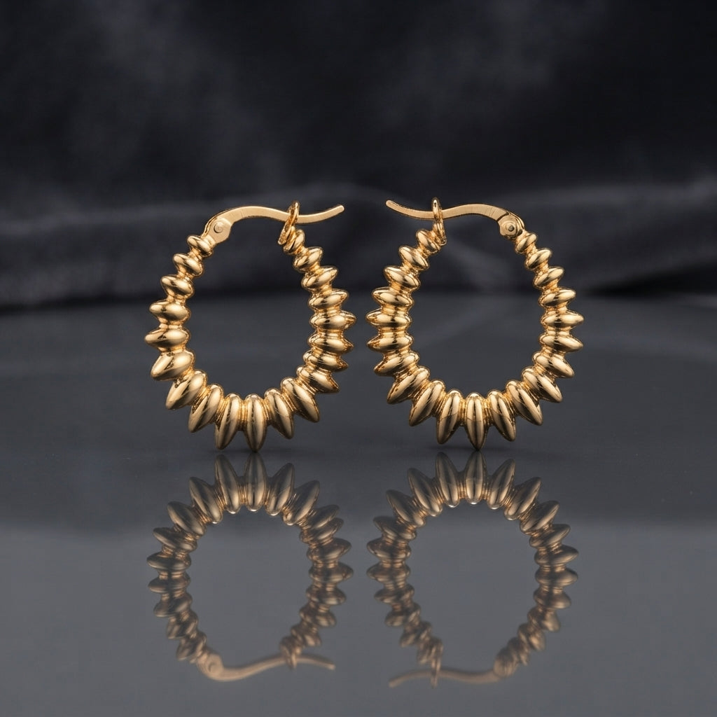 Gold PVD Stainless Steel Layered Disc Rondelle Spike Hoop Earrings pair on dark mirror surface with charcoal slate satin backdrop showing 18K gold PVD coated stainless steel statement hoops with continuous layered flat disc rondelle beads fanned in spike sunburst clusters tightly packed around full hoop circumference with sharp mirror reflection below