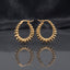 Gold PVD Stainless Steel Layered Disc Rondelle Spike Hoop Earrings pair on dark mirror surface with charcoal slate satin backdrop showing 18K gold PVD coated stainless steel statement hoops with continuous layered flat disc rondelle beads fanned in spike sunburst clusters tightly packed around full hoop circumference with sharp mirror reflection below