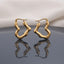 Gold PVD Stainless Steel Organic Wavy Abstract Freeform Hoop Earrings pair standing side by side on dark grey mirror surface with soft warm cream ivory fabric backdrop showing 18K gold PVD coated stainless steel hoops with chunky puffy tube body in organic undulating wavy abstract freeform silhouette satin matte finish with French lever closure and sharp mirror reflection below