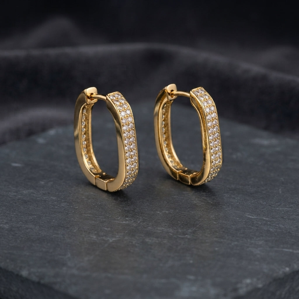 Silver-tone rounded-rectangle hoop earrings with pavé-style clear stones.