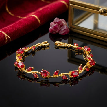 Gold-Tone Pink Morganite CZ Oval & Marquise Vine Wave Tennis Bracelet on dark reflective surface with amethyst crystals and Jo Malone perfume bottle backdrop
