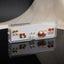 Gold Red Tulip Floral Enamel Pearl CZ 4-Pair Stud Earring Set flat lay on black marble surface with beige backdrop showing gold double ball studs red crimson tulip enamel studs with green leaf silver CZ pearl drop studs and large red burgundy enamel oval stud with two large faux pearls green leaf detail red clover and silver CZ snowflake cluster with mirror reflections below