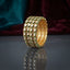 Gold Round Kundan Polki Green Enamel Wide Cuff Bangle Set of 4 standing upright on dark grey mirror surface with teal and burgundy velvet backdrop showing four matching wide gold bangles stacked as wide cuff with rows of round flat-cut CZ kundan polki stones in green enamel borders and gold filigree lattice interior with mirror reflection below