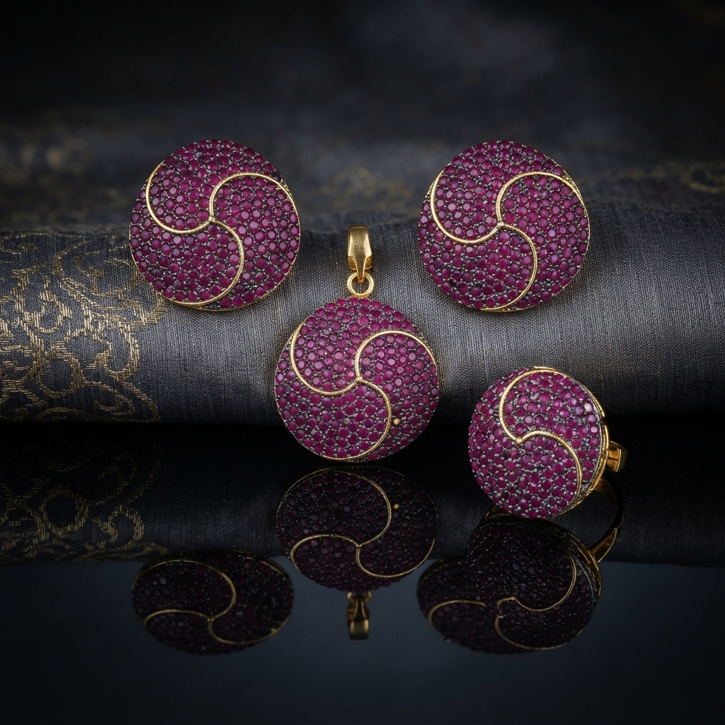 Gold-Tone Ruby Red CZ Swirl Dome Pendant & Earrings Jewelry Set on dark brocade fabric surface