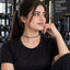 Gold Sapphire Blue Round CZ Tennis Necklace worn by model in black outfit at gym setting